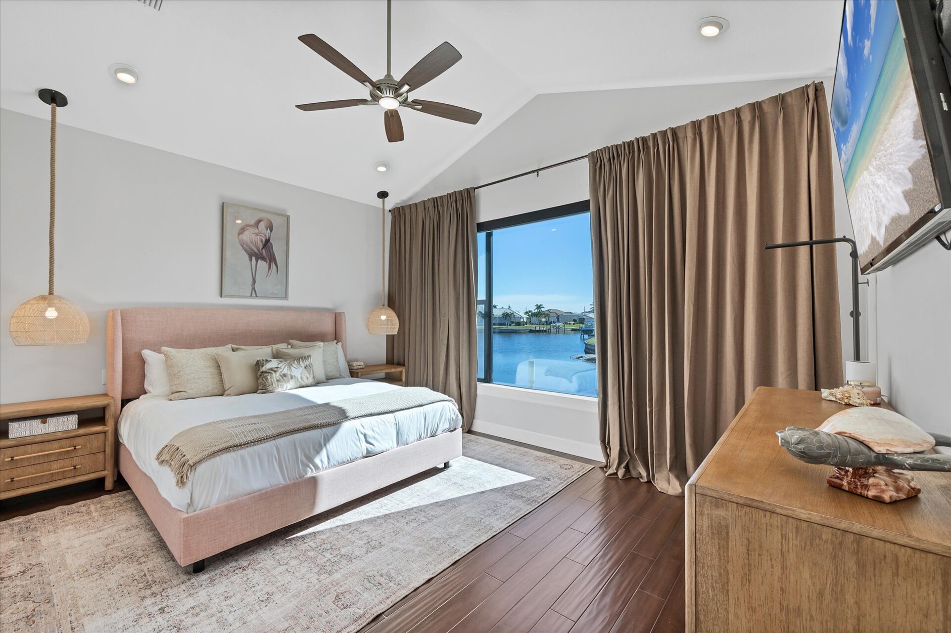 Guest bedroom 1 with king bed 65-inch Smart TV, and fabulous water view
