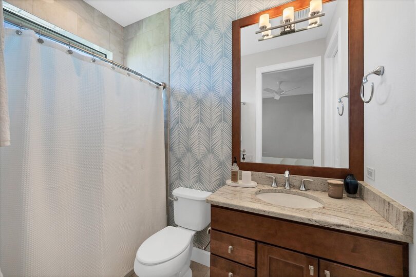 Guest bedroom 3's attached bathroom with shower/tub combo