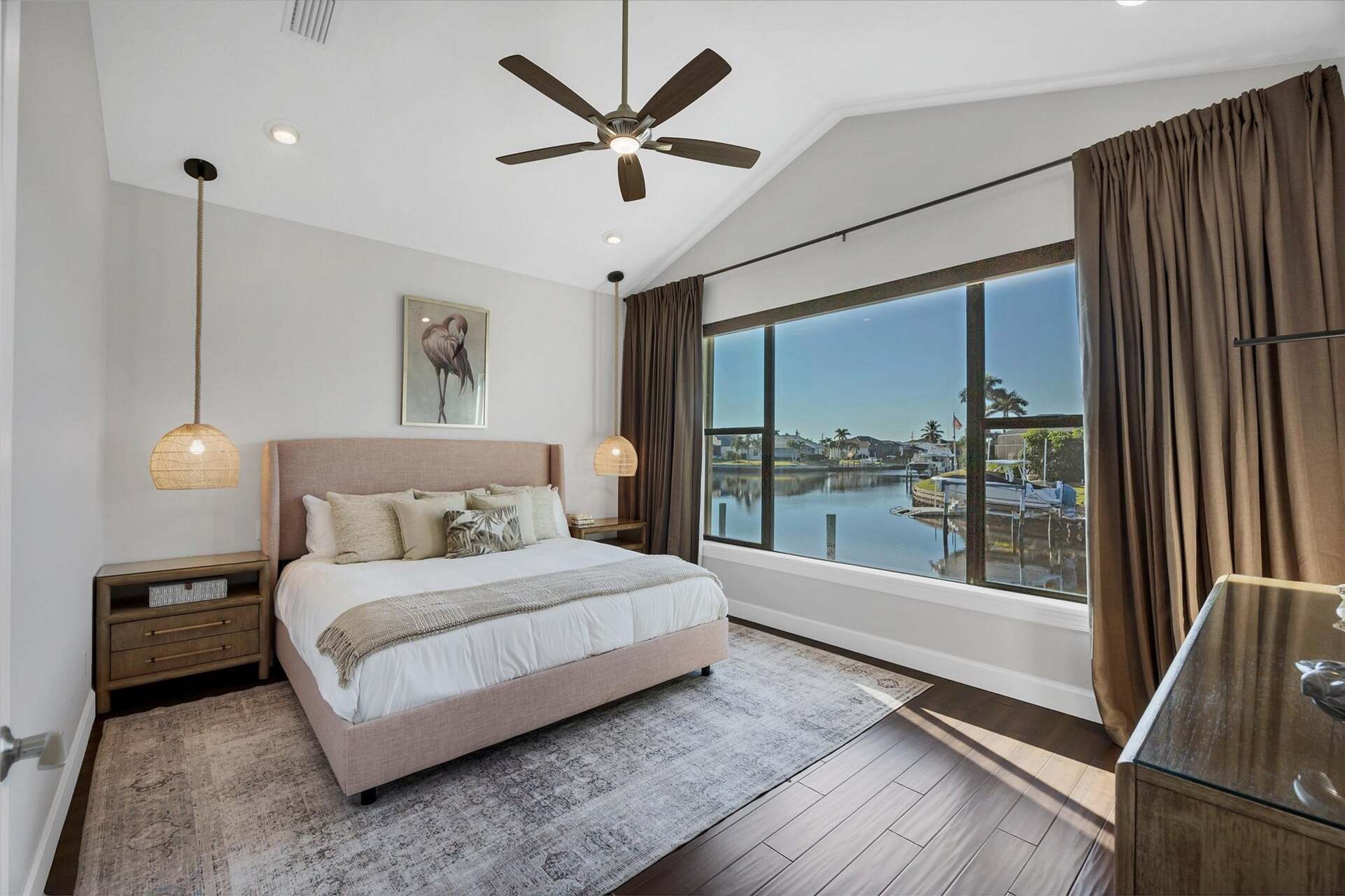 Guest bedroom 1 with king bed 65-inch Smart TV, and fabulous water view