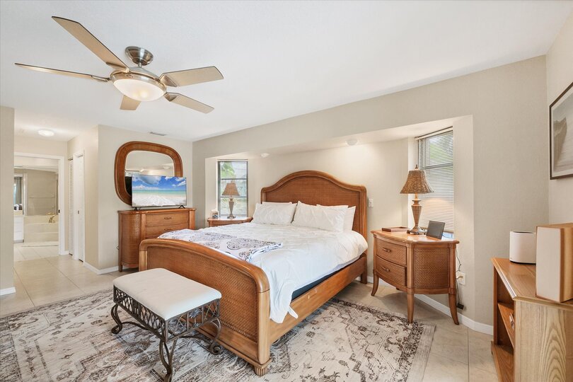 Primary Bedroom with King Bed, Attached Bathroom, Lanai Access, and 43" Smart TV