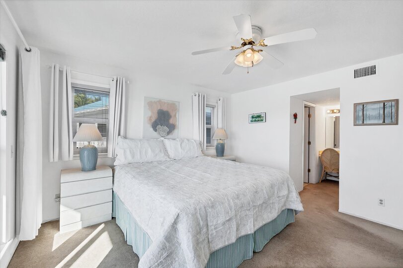 Primary bedroom with king bed, attached bathroom, balcony access and amazing water view