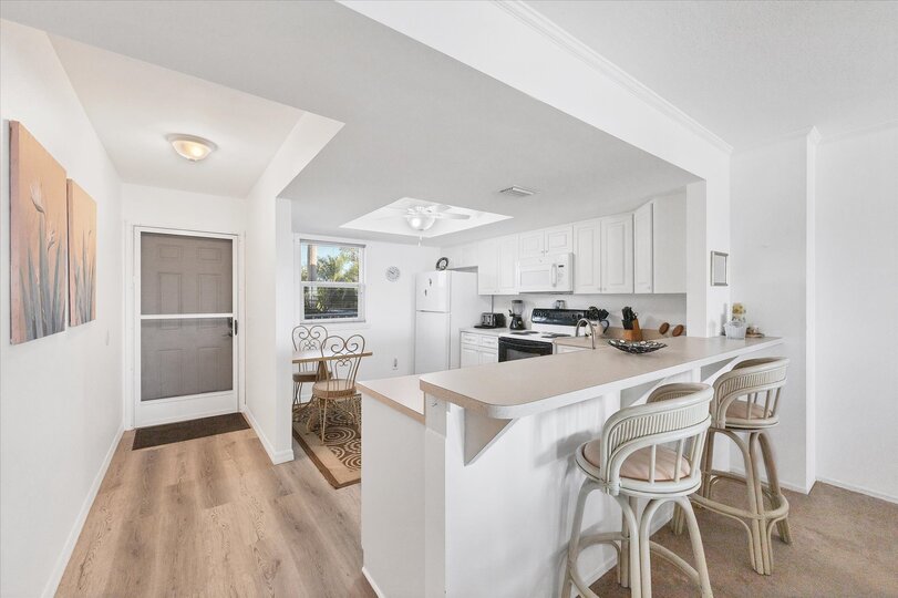 Fully-equipped kitchen overlooking dining and living room areas