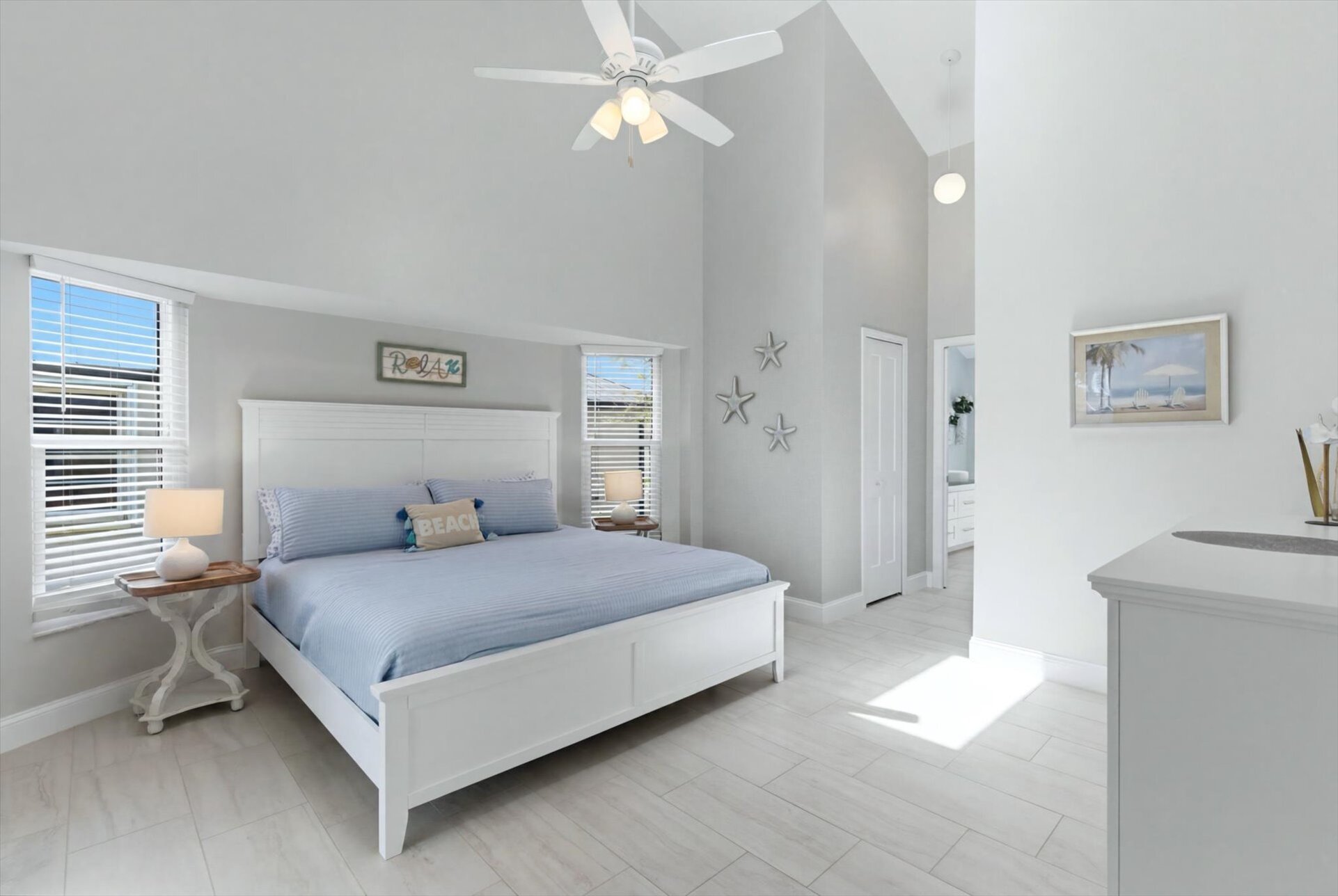 Bedroom 1 - primary bedroom with king bed, attached bathroom, lanai access, and 43" Smart TV