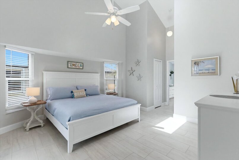 Bedroom 1 - primary bedroom with king bed, attached bathroom, lanai access, and 43" Smart TV
